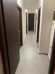 a hallway with several doors and a tile floor at Centrally Located Private Rooms in Heraklio Town