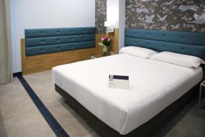 Postel nebo postele na pokoji v ubytování Hotel Palace