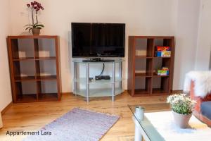 Televízia a/alebo spoločenská miestnosť v ubytovaní Appartement Lara & Lea