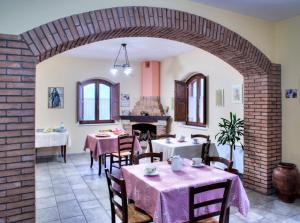 a dining room with tables and a brick wall at I Dolci Grappoli in Larino