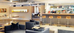 a bar with couches and a counter in a room at Heitlinger Hof in Tiefenbach