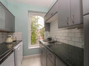 a kitchen with a counter top and a window at Belvedere in Buxton