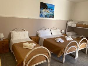 Postel nebo postele na pokoji v ubytování Cimalù by Lampara