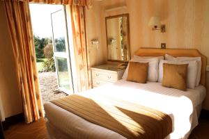 a bedroom with a bed and a large window at The Devoncourt Resort in Exmouth