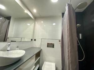 a white bathroom with a sink and a mirror at SOL 22 in Vigo