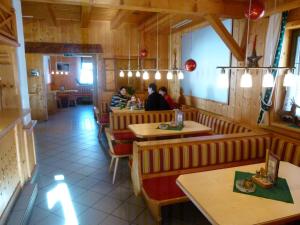 a restaurant with people sitting at tables in it at Base-Camp Appartement in Donnersbachwald