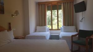 Cama o camas de una habitación en Hotel Turmo
