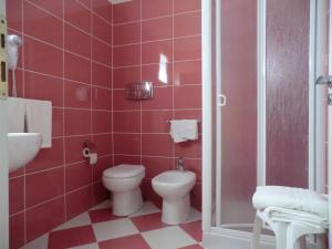 a red bathroom with a toilet and a sink at Mediterraneo Mare e Sole in Marina di Palma +32 photos