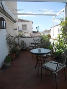 
a patio area with a table and chairs at Hotel Santa Isabel La Real in Granada
