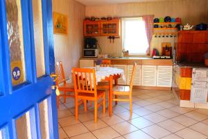 a kitchen with a table and chairs in a room at Chata na końcu świata in Rzuchowa