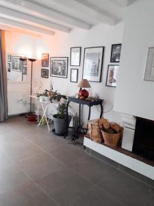 a living room with a table and pictures on the walls at Les portes du soleil in Les Sables-d'Olonne