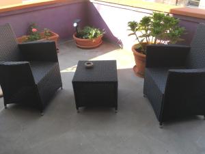 a group of chairs and a table and some plants at B&B Luce Viola in Dorgali +136 photos