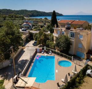 a swimming pool in a villa with a view of the ocean at Hotel Marialena in Potos