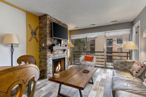 a living room with a couch and a fireplace at New Claim Traveler in Park City