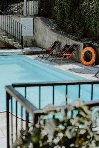 a group of chairs sitting next to a swimming pool at Vincent in Kazimierz Dolny