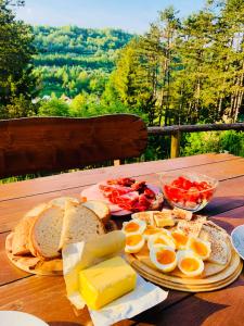 a table with eggs and bread and cheese on it at Drevenica Jánošík in Terchová