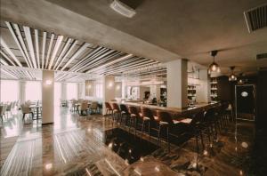 a restaurant with a bar with chairs and a counter at Imperia Apartments in Vrnjačka Banja