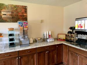 a kitchen with a counter top with a coffee maker at The Covered Bridge Inn in Brattleboro