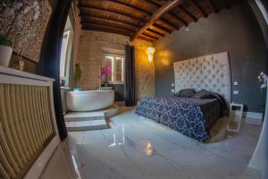 a bedroom with a tub and a bed and a sink at Rhome Luxury suite in Rome