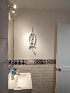 a bathroom with a white sink and a mirror at Marina Beach-Apartamentos Tahiche in Costa Teguise +11 photos