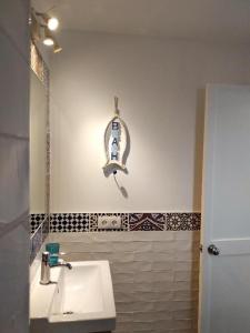 a bathroom with a white sink and a mirror at Marina Beach-Apartamentos Tahiche in Costa Teguise
