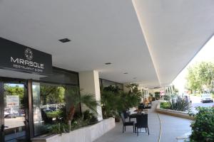 a restaurant with a table and chairs in a building at Hotel Mirasole International in Gaeta