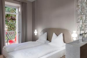 Postel nebo postele na pokoji v ubytování Boutique Hotel Imperialart
