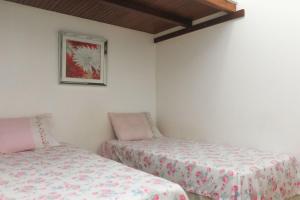Cama ou camas em um quarto em Ipanema Sunset Apartment