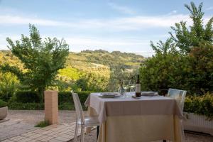 a table with a bottle of wine on top at Casa de Campo B&B in San Giovanni Teatino