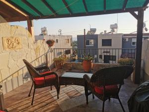 a patio with chairs and a table on a balcony at MEDITERRANEAN VALLEY in Paphos City