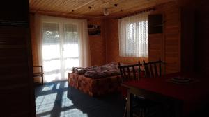 a room with a bed and a window and a table at Wodolenka in Hrádek