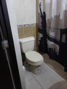 een badkamer met een wit toilet in een kamer bij Departamentos Mazatlán in Mazatlán