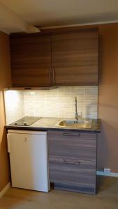 a kitchen with a sink and a counter top at På Hjørnet Gjestehus in Skjervøy
