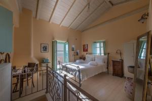 a bedroom with a bed and a balcony at Villa Dimitra - Mani , traditional archontiko in Dhirós +90 photos