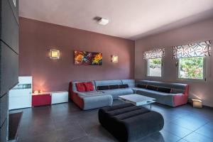 a living room with a couch and a table at Villa Iris in Livadi