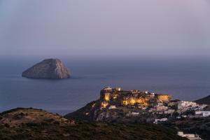 a castle on top of a mountain in the ocean at Villa Iris in Livadi