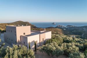 an image of a house with the ocean in the background at Villa Iris in Livadi
