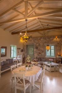 a large living room with a table and chairs at Villa Dimitra - Mani , traditional archontiko in Dhirós