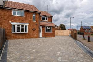 a brick house with a driveway in front of it at Like Your Own Private Hotel in Luton