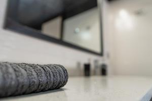 a stack of tires sitting on the floor in front of a mirror at Villa Iris in Livadi