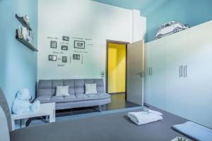 a living room with a couch and a yellow door at Villa Iris in Livadi