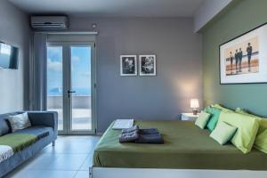a bedroom with a large bed and a couch at Villa Iris in Livadi