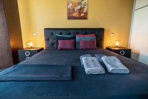 a bedroom with a bed with two towels on it at Villa Iris in Livadi