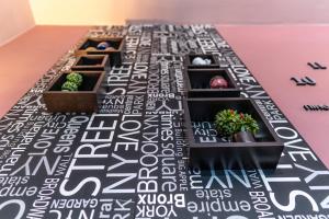 a table with three plants on a black and white table at Villa Iris in Livadi