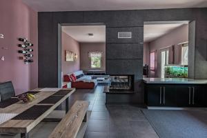 a living room with a table and a fireplace at Villa Iris in Livadi