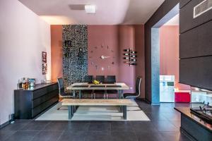 a dining room with a table and a clock on the wall at Villa Iris in Livadi