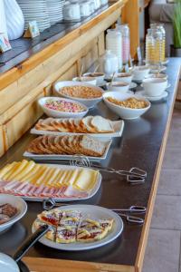 a buffet with many plates of food on a table at Sol del Nahuel - Hotel & Spa in San Carlos de Bariloche