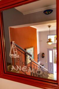 a reflection of a stair case in a mirror at Anemos Studios & Apartments in Poros