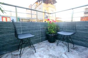 two chairs on a balcony with a potted plant at Grand Moon Hotel Suites in Istanbul