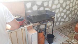a man standing in a kitchen with a stove at Apartments Residence by Tourist in Poreč